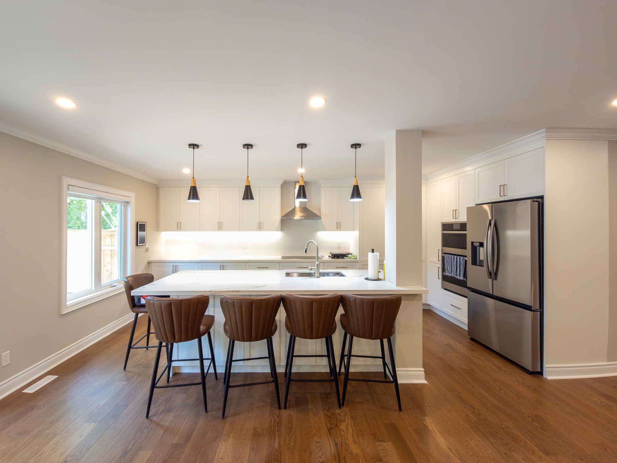 White kitchen with a warm oak island