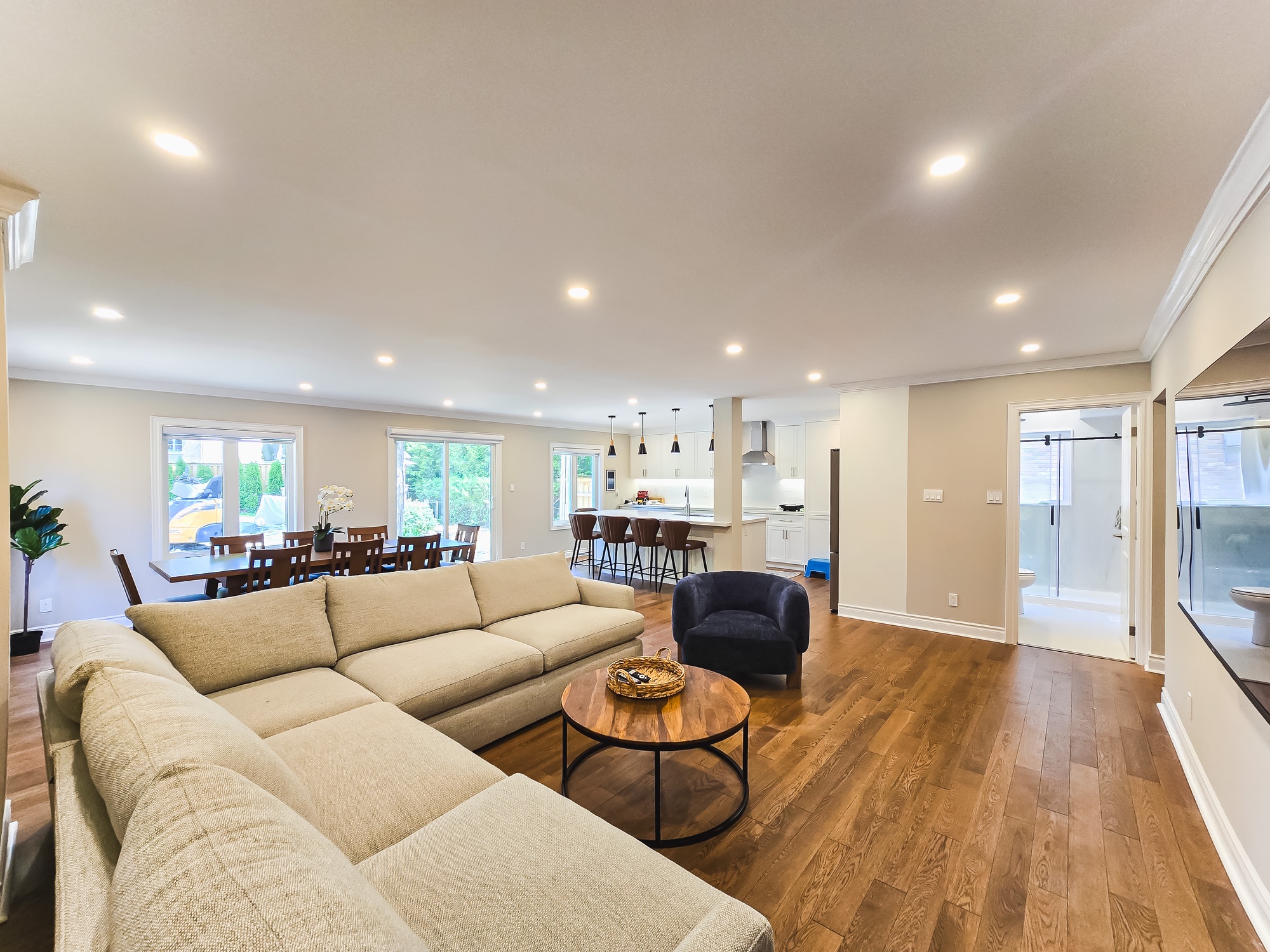 Living, dining and kitchen spaces connected by a completed residential extension