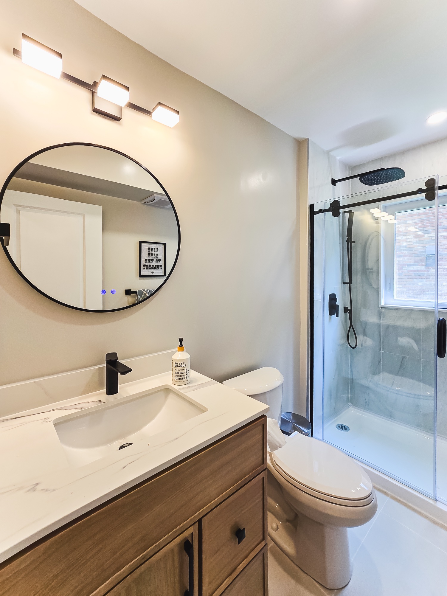 Bathroom vanity and glass shower with black fixtures